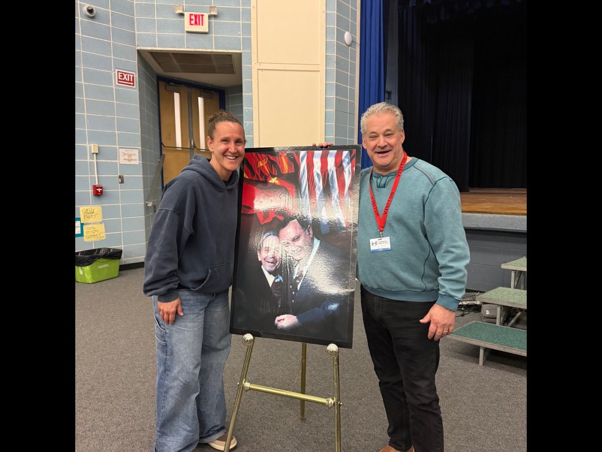 Pictured are speaker, Jeff Zieger, and Ms. Holak, 8th grade ELA teacher who organized the assembly. 